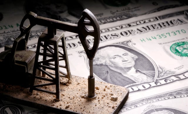 A 3D-printed oil pump jack is placed on dollar banknotes in this illustration picture, April 14, 2020. REUTERS/Dado Ruvic/Illustration/File Photo