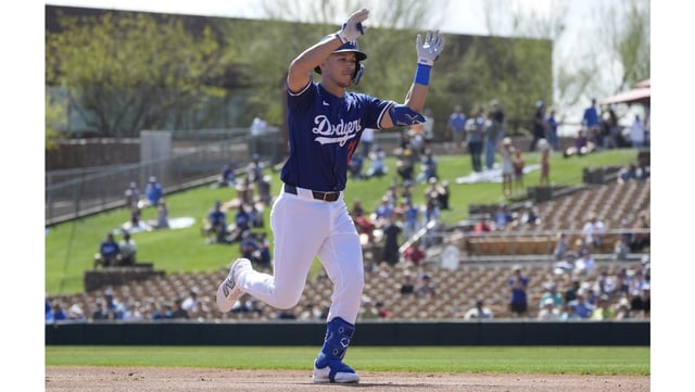 The Dodgers’ Tommy Edman celebrates as he runs the bases after hitting a two-run home run during the first inning of their Cactus League game against the Cleveland Guardians on Tuesday in Glendale, Ariz. (AP Photo/Ross D. Franklin)