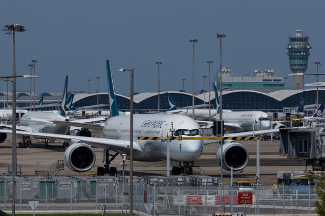 Cathay Pacific aircraft are seen parked at Hong Kong International Airport in Hong Kong, China August 7, 2024. REUTERS/Tyrone Siu/File Photo