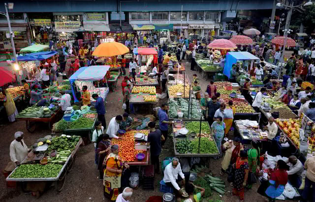 Customers buy fruits and vegetables at an open air evening market in Ahmedabad, India, August 21, 2023. REUTERS/Amit Dave/File Photo
