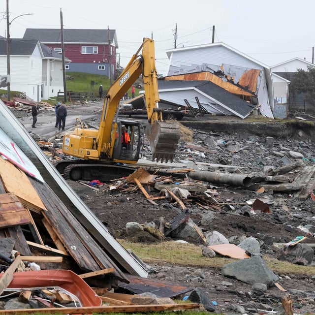 Meteorologists and scientists say sweeping cuts to the National Oceanic and Atmospheric Administration in the United States will be felt in Atlantic Canada — particularly during hurricane season. A heavy machinery operator continues the cleanup from post-tropical storm Fiona in Port aux Basques, N.L., on Thursday, Sept. 29, 2022. THE CANADIAN PRESS/Frank Gunn
