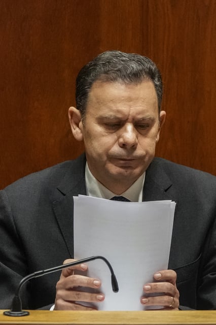 Portuguese Prime Minister Luis Montenegro sits after his speech during a debate preceding a confidence motion vote at the Portuguese parliament in Lisbon, Tuesday, March 11, 2025. (AP Photo/Armando Franca)