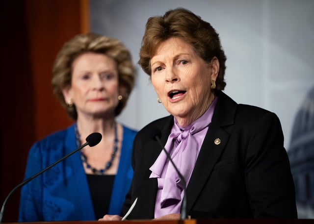 Senator Jeanne Shaheen (D-NH) speaks with Senator Debbie Stabenow (D-MI), left, at a press conference about the Nation Security Supplemental on Dec. 6, 2023 in Washington, D.C.