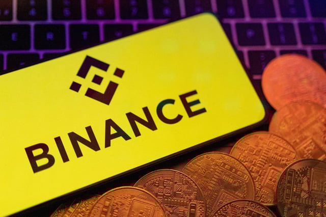 Smartphone with displayed Binance logo and representation of cryptocurrencies are placed on a keyboard in this illustration taken, June 8, 2023. REUTERS/Dado Ruvic/Illustration/File Photo
