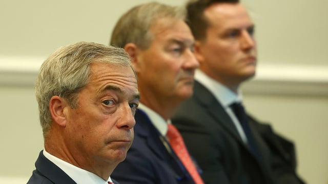 Nigel Farage next to Rupert Lowe at a Reform news conference in October