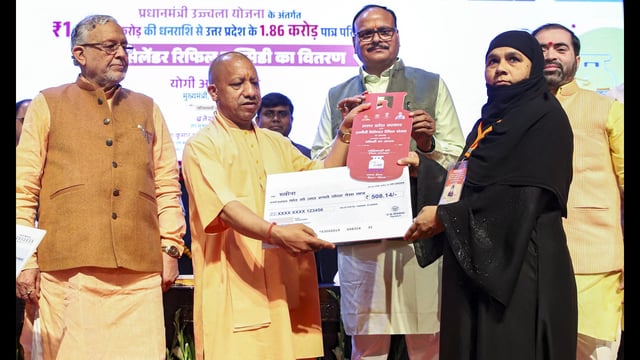 UP chief minister Yogi Adityanath with deputy chief minister Brajesh Pathak during the distribution of LPG cylinder refill subsidy to beneficiaries under the 'Pradhan Mantri Ujjwala Yojana', in Lucknow. (PTI)