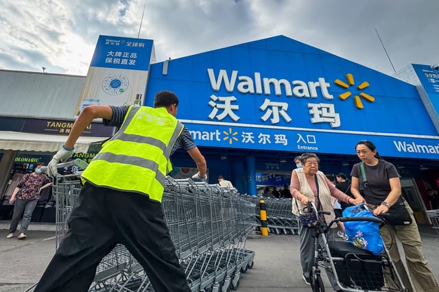 A Walmart employee outside of a store in Shenzhen, China. As Walmart continues to dominate the Chinese market, it&#39;s now facing rising tariffs on imports from its suppliers in the country.