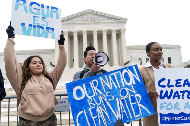 FILE - Bethsaida Sigaran, left, of Baltimore, her brother Jaime Sigaran, with American Rivers, and Thea Louis, with Clean Water Action, join supporters of the Clean Water Act as they demonstrate outside the Supreme Court, Oct. 3, 2022, in Washington, as the court begins arguments in Sackett v. Environmental Protection Agency (EPA). (AP Photo/Jacquelyn Martin, File)