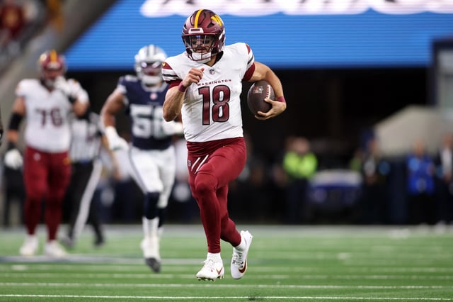 Jan 5, 2025; Arlington, Texas, USA; Washington Commanders quarterback Marcus Mariota (18) runs for a first down against the Dallas Cowboys during the fourth quarter at AT&T Stadium. Mandatory Credit: Tim Heitman-Imagn Images/File Photo
