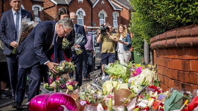 Sir Keir Starmer, pictured paying his respects to the victims of the Southport stabbings, has called for terrorism laws to be expanded to cover violent lone attackers following the atrocity