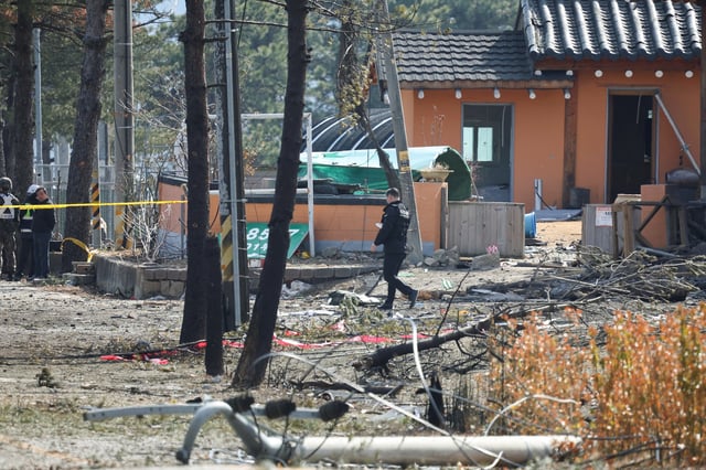 A police officer walks at a cordoned area after South Korea's Air Force said that Mk82 bombs fell from a KF-16 jet outside the shooting range during joint live-fire exercises near the demilitarized zone separating two Koreas in Pocheon, South Korea, March 6, 2025. REUTERS/Kim Hong-Ji
