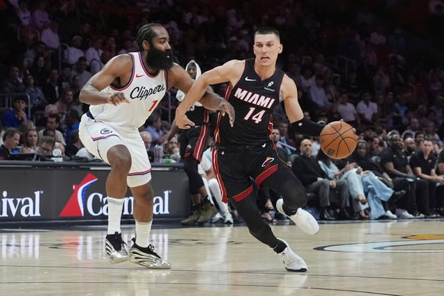 LA Clippers guard James Harden (1) defends Miami Heat guard Tyler Herro (14) during the first half of an NBA basketball game, Wednesday, March 12, 2025, in Miami. (AP Photo/Marta Lavandier)