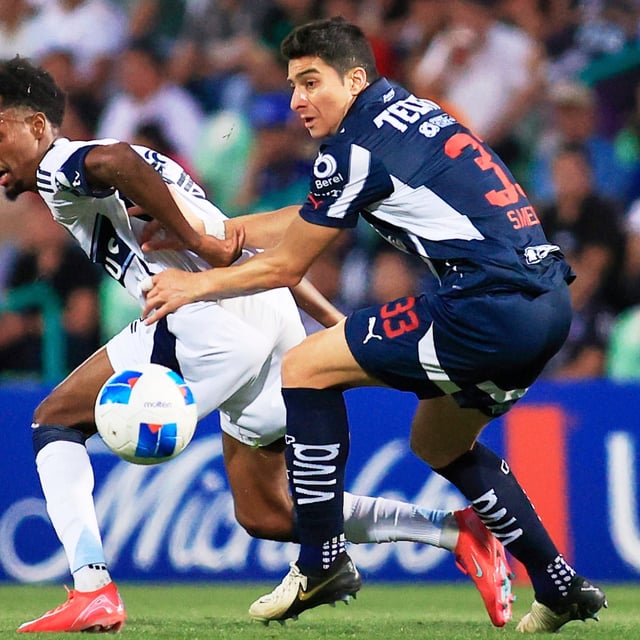 Ali Ahmed of Canada's Vancouver Whitecaps, left, and Stefan Medina of Mexico's Monterrey fight for the ball during a CONCACAF Champions Cup soccer match at Corona stadium in Torreon, Mexico, Wednesday, March 12, 2025. (AP Photo/Jesus Gonzalez)