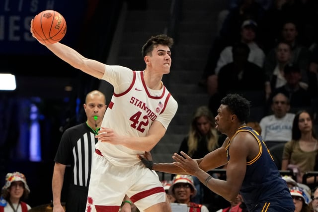Mar 12, 2025; Charlotte, NC, USA; Stanford Cardinal forward Maxime Raynaud (42) passes the ball as California Golden Bears center Mady Sissoko (12) defends in the second half at Spectrum Center. Mandatory Credit: Bob Donnan-Imagn Images