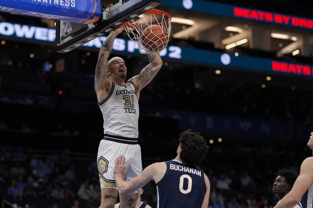 Mar 12, 2025; Charlotte, NC, USA; Georgia Tech Yellow Jackets forward Duncan Powell (31) with a dunk against Virginia Cavaliers forward Blake Buchanan (0) during the second half at Spectrum Center. Mandatory Credit: Jim Dedmon-Imagn Images