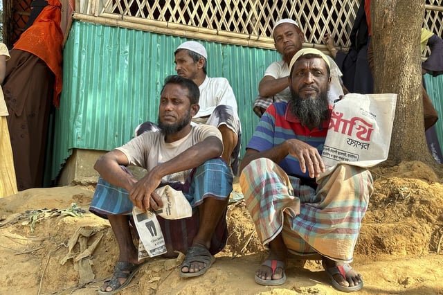 Rohingya refugees wait for food to be distributed during the Islamic holy month of Ramadan at their camp in Cox's Bazar, Bangladesh, Thursday, March 6, 2025. (AP Photo/Shafiqur Rahman)