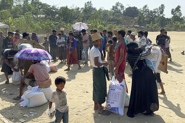 Rohingya refugees collect food stuff distributed by the World Food Programme (WFP) at their refugee camp at Kutupalong in Cox's Bazar, Bangladesh, Thursday, March 6, 2025. (AP Photo/Shafiqur Rahman)