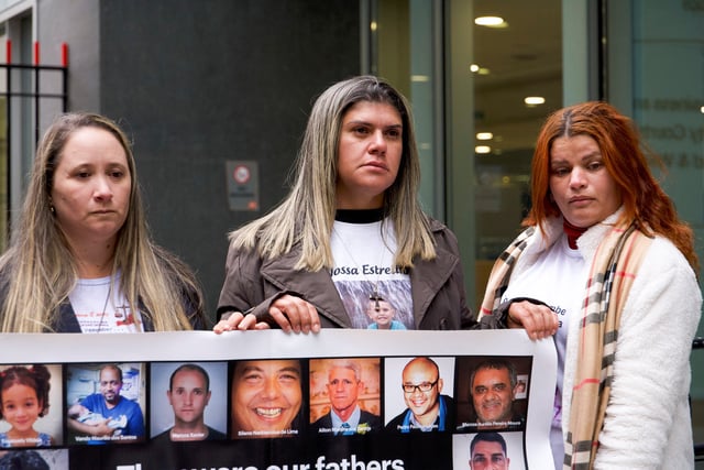 Victims of Brazilian dam collapse Gelvana Silva, Monia Dos Santos and Pamela Fernandes hold a banner outside City Court House, Rolls Building ahead of the final day of the lawsuit against BHP in London, Britain, March 13, 2025. REUTERS/Marissa Davison