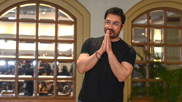 Aamir Khan posed for the media but Gauri avoided cameras.