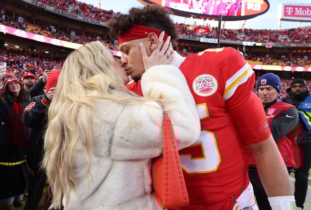 Patrick Mahomes #15 of the Kansas City Chiefs kisse wife, Brittany Mahomes, prior to the AFC Championship Game against the Buffalo Bills at GEHA Field at Arrowhead Stadium on January 26, 2025 in Kansas City, Missouri.