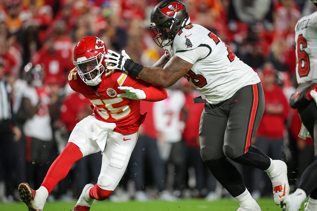 Tristan Wirfs #78 of the Tampa Bay Buccaneers blocks Joshua Uche #55 of the Kansas City Chiefs during the first quarter at GEHA Field at Arrowhead Stadium on November 4, 2024.
