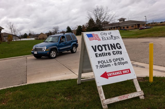 A sign directing voters to a polling site in Elkhorn, Wisconsin is seen on November 5, 2024.