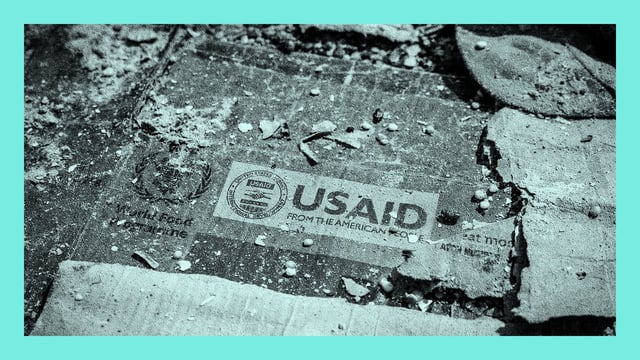 A USAID logo is visible on a cardboard box amid the scattered remains of boxes and materials in Bukavu, Democratic Republic of the Congo.