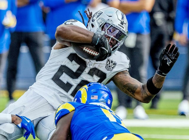 Las Vegas Raiders running back Alexander Mattison (22) fights for yards as Los Angeles Rams defenders try to tackle him in the first half of the game at SoFi Stadium in Inglewood on Sunday, Oct. 20, 2024. (Photo by Terry Pierson, The Press-Enterprise/SCNG)