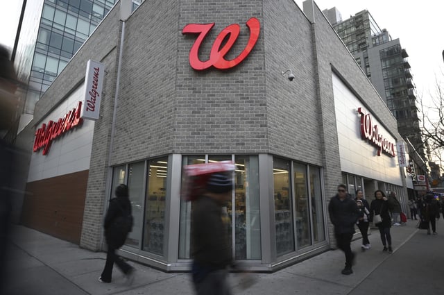 People walk past a Walgreens Pharmacy and retail store in the Queens borough of New York City, NY, March 12, 2025.
