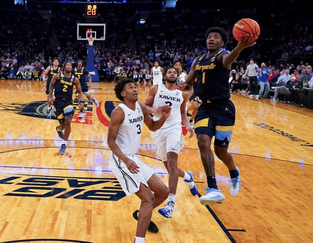 Mar 13, 2025; New York, NY, USA;  Marquette Golden Eagles guard Kam Jones (1) drives on Xavier Musketeers guard Dailyn Swain (3) and forward Jerome Hunter (2) at Madison Square Garden. Mandatory Credit: Robert Deutsch-Imagn Images