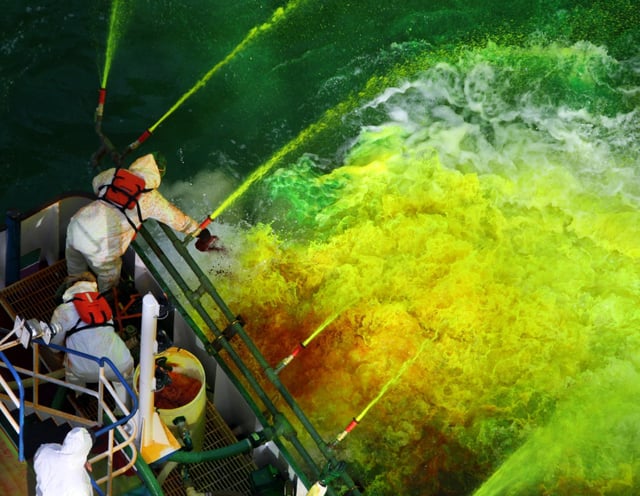 Workers dye the Chicago River green on March 11, 2017, ahead of St. Patrick&#39;s Day. (John J. Kim/Chicago Tribune)