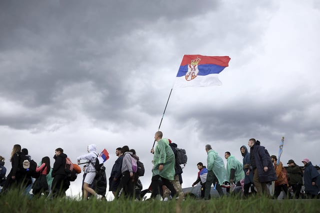 Students and anti-government protesters march towards Belgrade for a joint protest after a break in Cortanovci, Serbia, Thursday, March 13, 2025. (AP Photo/Armin Durgut)