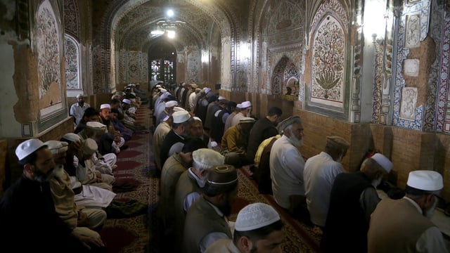 Muslims attend first Friday prayers during the Muslim holy fasting month of Ramadan, at the historic Mahabat Khan Mosque, in Peshawar, Pakistan, Friday, March 7, 2025. (AP Photo/Muhammad Sajjad)