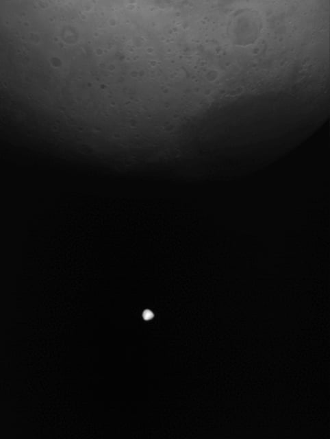 Hera caught the moon Deimos crossing Mars on March 12, 2025. The spacecraft used a flyby of Mars to boost it to its final destination, the asteroid Didymos. Her was about 1,000 km away from the moon Deimos as it took these images. Image via ESA/ JAXA.