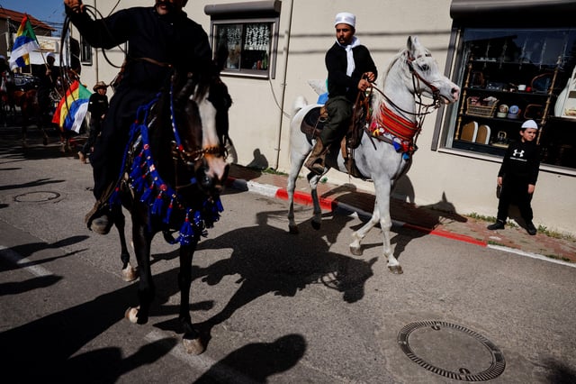 People ride horses on the day Israeli Druze leader Sheik Mowafaq Tarif and around 100 Syrian Druze religious elders, in the first Druze delegation from Syria just after 1973 war, visit the Nabi Shuayb Shrine, a holy place for the Druze community, in northern Israel March 14, 2025. REUTERS/Ammar Awad