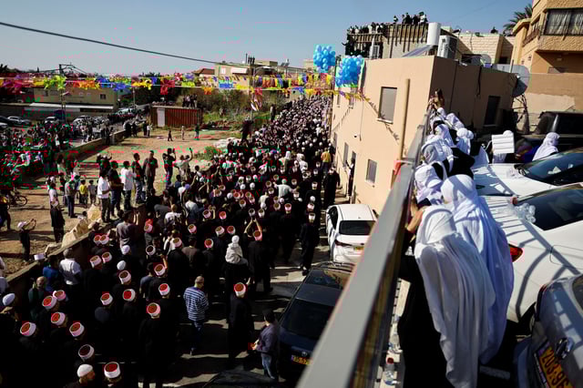 People gather on the day Israeli Druze leader Sheik Mowafaq Tarif and around 100 Syrian Druze religious elders, in the first Druze delegation from Syria just after 1973 war, visit the Nabi Shuayb Shrine, a holy place for the Druze community, in northern Israel March 14, 2025. REUTERS/Ammar Awad