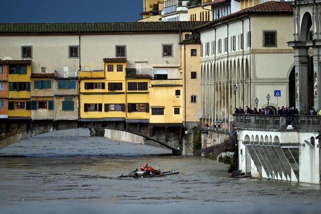 Rainfall swells the Arno river under the Ponte Vecchio bridge in Florence on Friday