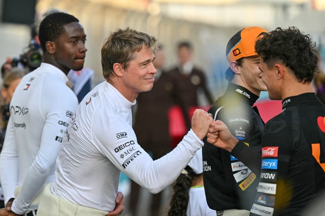 US actor Brad Pitt (C), who is filming for the movie F1 directed by Joseph Kosinski, greets McLaren&#39;s British driver Lando Norris as he arrive before the start of the Abu Dhabi Formula One Grand Prix at the Yas Marina Circuit in Abu Dhabi on December 8, 2024.