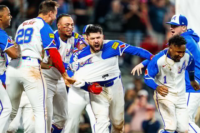 Travis d&#39;Arnaud #16, Orlando Arcia #11, Austin Riley #27 and Ozzie Albies #1 of Atlanta Braves celebrate after d&#39;Arnaud&#39;s walk-off home run in the ninth inning against the Kansas City Royals at Truist Park on September 28, 2024 in Atlanta.