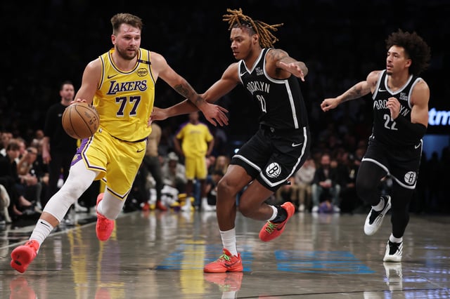 Luka Doncic #77 of the Los Angeles Lakers dribbles as Noah Clowney #21 and Jalen Wilson #22 of the Brooklyn Nets defend during the second half at Barclays Center on March 10, 2025 in the Brooklyn borough of New York City. The Nets won 111-108. NOTE TO USER: User expressly acknowledges and agrees that, by downloading and or using this photograph, User is consenting to the terms and conditions of the Getty Images License Agreement. (Photo by Sarah Stier/Getty Images)