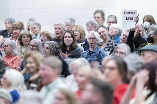 People react during a congressional town hall meeting with Rep. Chuck Edwards (R-NC) on March 13, 2025 in Asheville, North Carolina. The event comes as Republicans have faced protestors at town halls critical of the Trump administration slashing federal jobs.