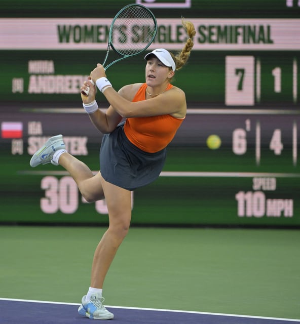 Mar 14, 2025; Indian Wells, CA, USA;  Mirra Andreeva (RUS) hits a shot during her semifinal match defeating Iga Swiatek (not pictured) at the BNP Paribas Open at the Indian Well Tennis Garden. Mandatory Credit: Jayne Kamin-Oncea-Imagn Images