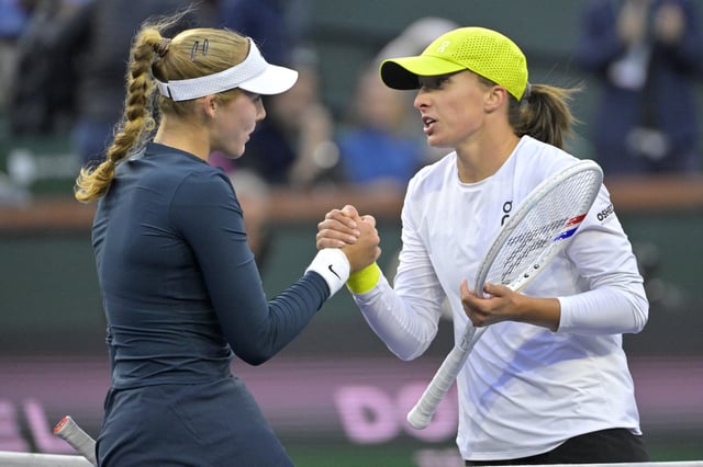 Mar 14, 2025; Indian Wells, CA, USA;  Mirra Andreeva (RUS) shakes hands with Iga Swiatek (POL) after winning her semifinal match at the BNP Paribas Open at the Indian Well Tennis Garden. Mandatory Credit: Jayne Kamin-Oncea-Imagn Images