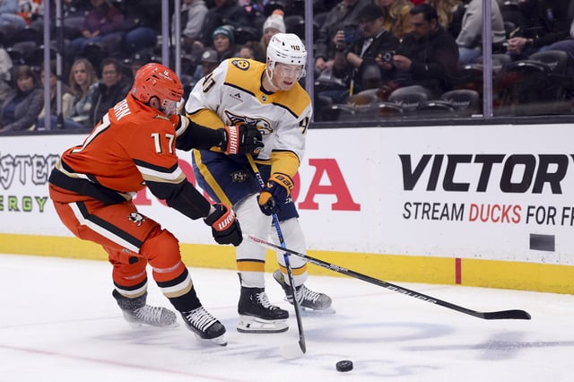 Mar 14, 2025; Anaheim, California, USA; Nashville Predators center Fedor Svechkov (40) and Anaheim Ducks left wing Alex Killorn (17) vie for the puck during the first period at Honda Center. Mandatory Credit: Ryan Sun-Imagn Images