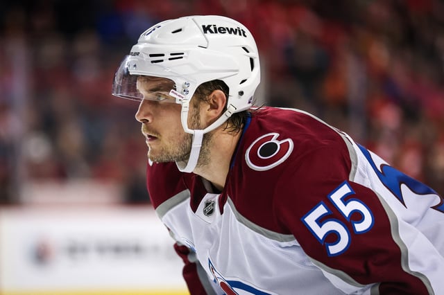 Mar 14, 2025; Calgary, Alberta, CAN; Colorado Avalanche defenseman Ryan Lindgren (55) during the face off against the Calgary Flames during the third period at Scotiabank Saddledome. Mandatory Credit: Sergei Belski-Imagn Images