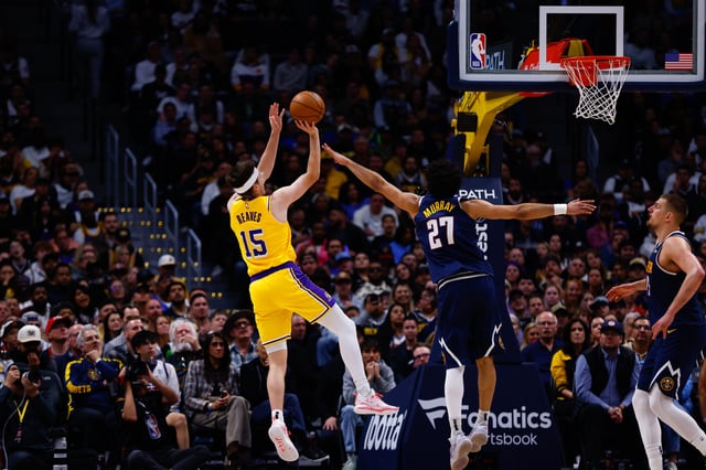 DENVER, CO - MARCH 14: Austin Reaves #15 of the Los Angeles Lakers shoots while being defended by Jamal Murray #27 of the Denver Nuggets during the fourth quarter at Ball Arena on March 14, 2025 in Denver, Colorado.