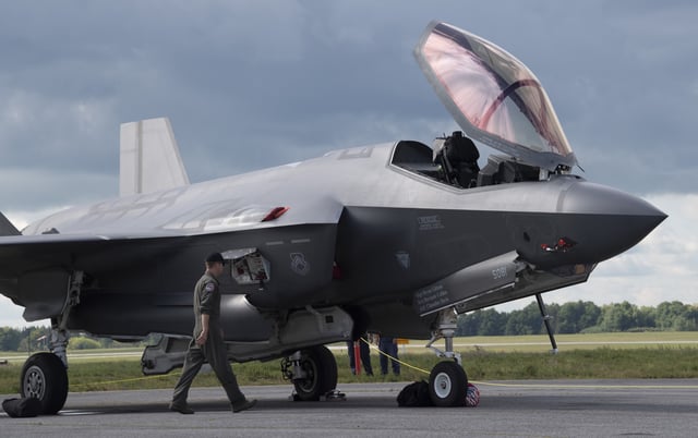 A US Air Force demonstration team pilot walks past one of two F-35A Lightning II fighter jets Wednesday September 4, 2019 in Ottawa. THE CANADIAN PRESS/Adrian Wyld