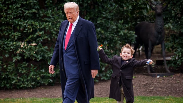Donald Trump and Æ A-Xii, the son of White House Senior Advisor, Tesla and SpaceX CEO Elon Musk, walks towards Marine One on the South Lawn of the White House.