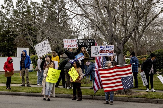 A group protests Tesla CEO Elon Musk outside the electric carmaker’s Sunnyvale showroom Saturday.
 