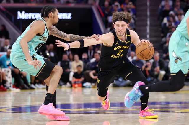 Golden State Warriors’ Brandin Podziemski drives against Charlotte Hornets’ Nick Smith Jr. at Chase Center in San Francisco on Tuesday, February 25, 2025.